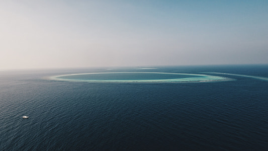 body of water under cloudy sky thumbnail