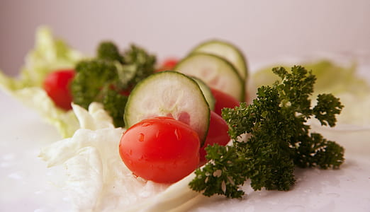 sliced cucumber and tomatoes with greens thumbnail
