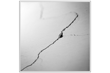 grayscale photo of cracked concrete wall thumbnail