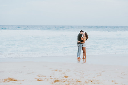 man and woman kissing near beach thumbnail