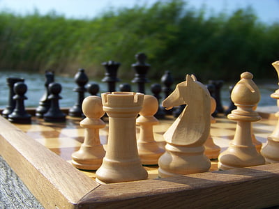 bokeh photography of wooden chessboard set thumbnail