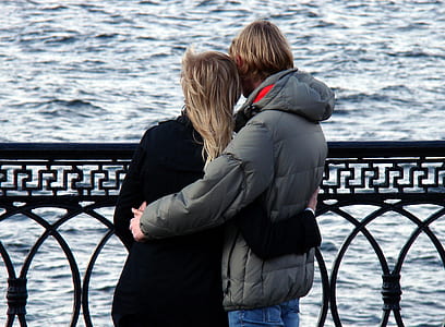 Man in Grey Bubble Jacket Beside Woman in Black Sweater thumbnail