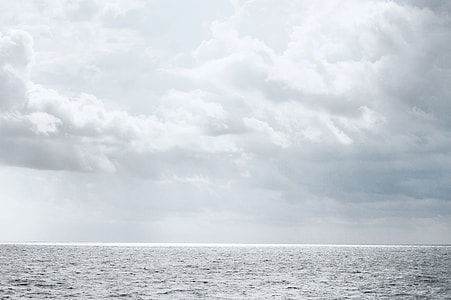 landscape photo of ocean under cloudy sky thumbnail