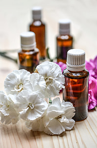 white Magnolia flowers with brown amber glass bottle thumbnail