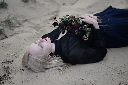 Woman Laying Holding Red Flowers thumbnail