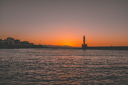 lighthouse on pier during sunset thumbnail