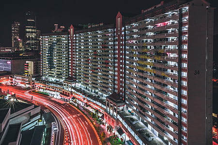 timelapse photography of vehicles near city buildings during nighttime thumbnail