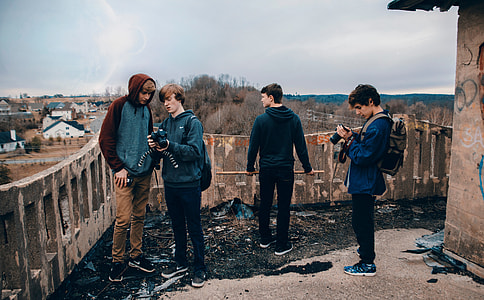 4 men in blue and grey jackets standing outside the house during daytime thumbnail