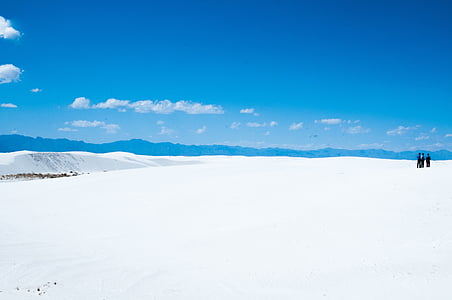 three people standing on ice field thumbnail