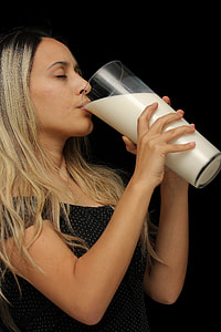woman drinking white liquid on glass thumbnail