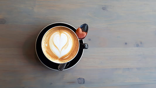 flat lay photography of heart coffee in mug thumbnail