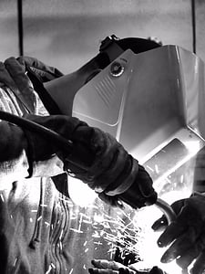 grayscale photo of man using acetylene torch with mask thumbnail