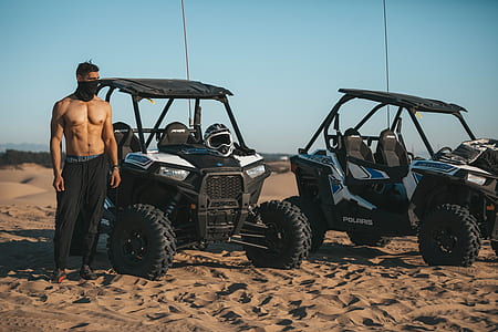 man standing beside UTV thumbnail