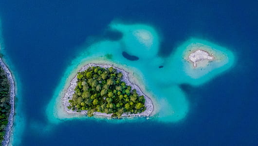 aerial photography of island surrounded by body of water thumbnail
