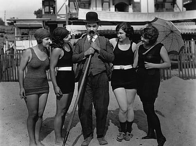 gray scale photography of man between four womens thumbnail