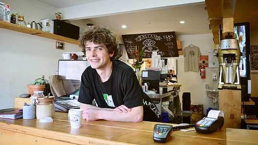 man in black crew-neck T-shirt near on brown table thumbnail