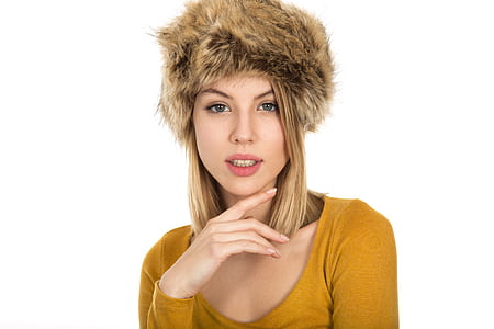 woman in yellow scoop-neck sweatshirt wearing brown fur beanie thumbnail