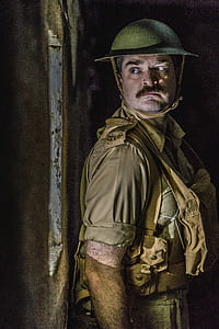 man hiding while looking through the window thumbnail