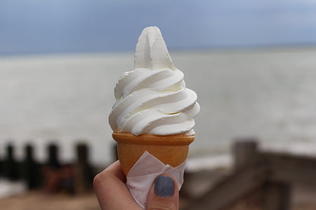 selective focus photography person holding ice cream thumbnail