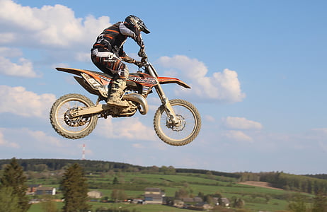 man riding on dirt bike photo thumbnail