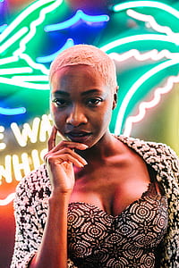 woman standing near neon signage thumbnail