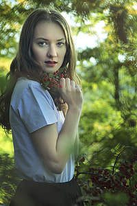 woman in blue shirt and black skirt near forest thumbnail