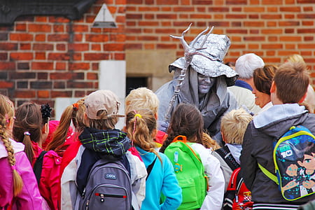 group of people surrounding man in costume thumbnail