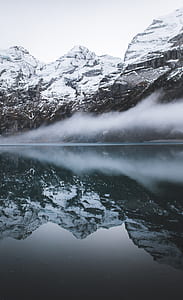 water still photography of snow-capped mountain with fogs thumbnail