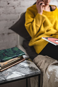 Young woman reading a magazine in bed thumbnail
