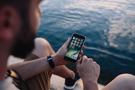 Mobile phone in man's hands near the sea thumbnail