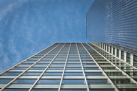 low angle photo of glass high rise building under clear blue sky thumbnail