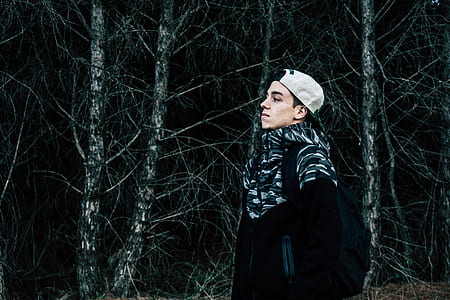 man wearing white hat near trees thumbnail