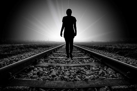 silhouette of person waling on railway thumbnail