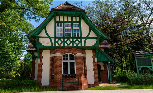 white and brown house beside tree thumbnail