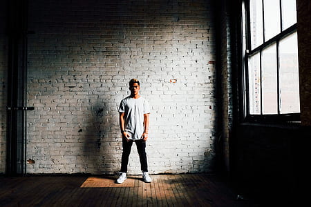 photo of man standing behind wall thumbnail