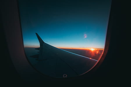 photo of airplane wings during sunset thumbnail