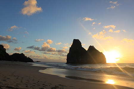 silhouette of rock formations on sea thumbnail
