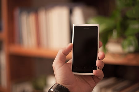 person holding white and black Nokia smartphone thumbnail