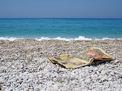 newspaper on seashore thumbnail