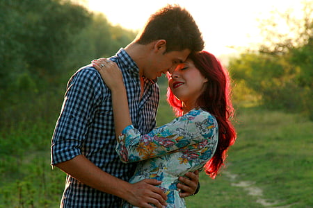 man and woman hugging each other in shallow focus photography thumbnail