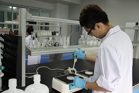 man in white suit holding white device inside laboratory thumbnail