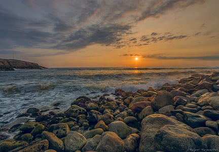 seawaves on rocks during golden hour thumbnail
