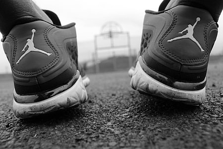 person wearing Air Jordan sneakers grayscale photo thumbnail