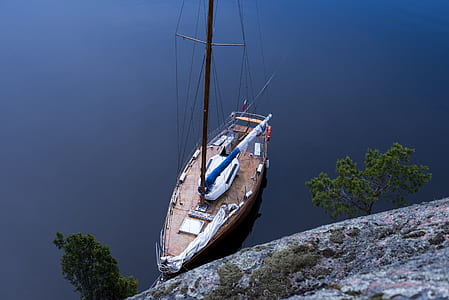 aerial photography of boat near rock formation thumbnail