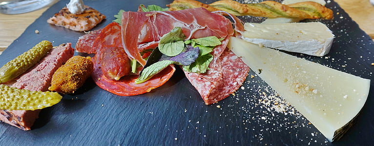 slice cheese and meat on black plate thumbnail