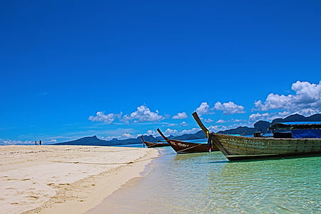 three brown boats on seashore thumbnail
