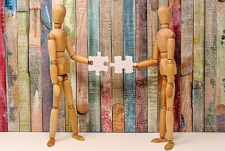 closeup photo of two brown wooden mannequins thumbnail
