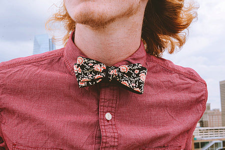 person wearing pink collared top with bow thumbnail