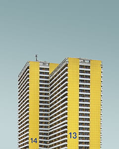 low-angle photography of yellow and white multi-storey building thumbnail