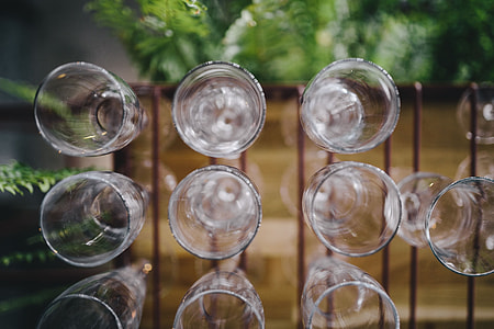 A big bunch of wine glasses hanging from a holder thumbnail